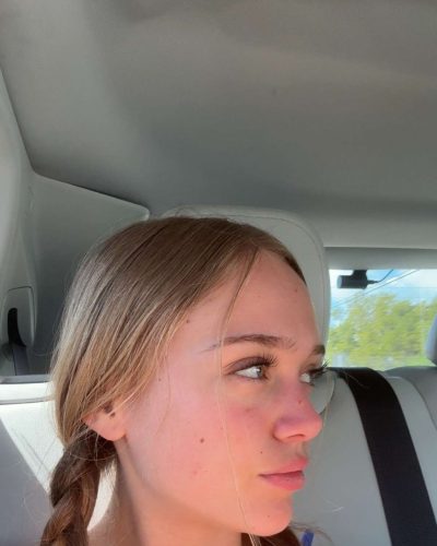 Kyla Dodds in blue bikini surrounded by friends.