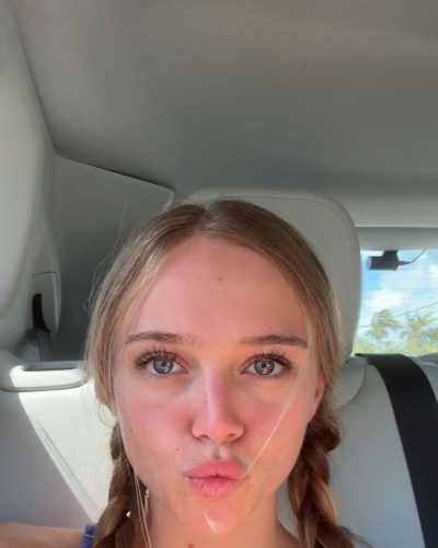 Kyla Dodds in blue bikini with ocean backdrop.