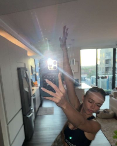 Kyla Dodds wearing black tank and fitted casual shorts.