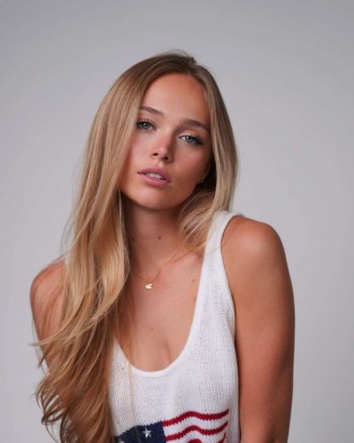 Kyla Dodds in casual white tank top and denim shorts