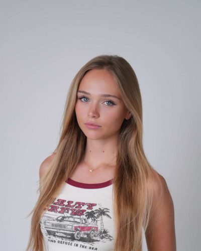 Kyla Dodds in casual white tank top and denim shorts