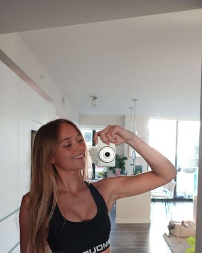 Kyla Dodds in oversized white tank top with American flag