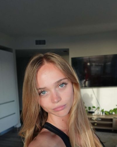 Kyla Dodds with flowing hair and white tank top
