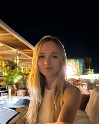 Kyla Dodds in brown striped bikini and sheer cover-up.