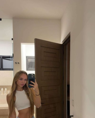 Kyla Dodds in fashionable brown bikini and sheer cover-up.