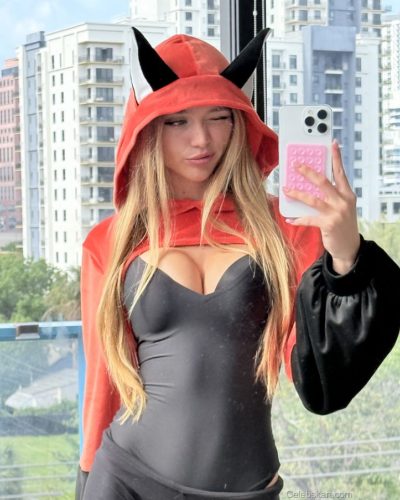 Kyla Dodds wearing chic brown striped bikini on beach.