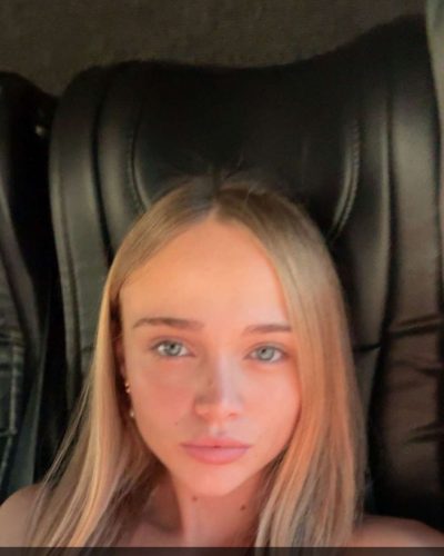 Kyla Dodds in light sheer cover-up by the shore.