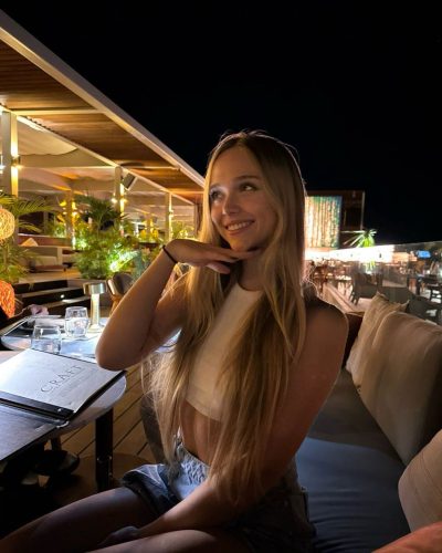 Kyla Dodds wearing chic brown striped bikini on beach.