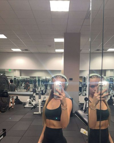 Kyla Dodds in black top and trendy blue athletic shorts