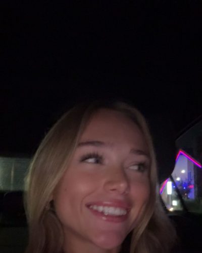 Kyla Dodds in black fitted top and flattering blue shorts