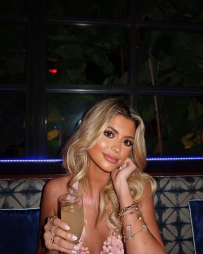 Kylan Darnell black bikini adorned with floral patterns and sunglasses