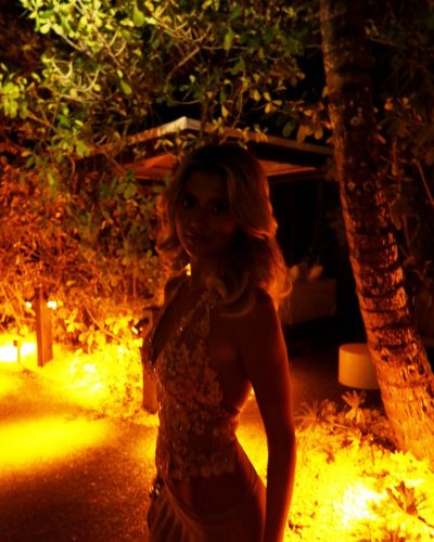 Kylan Darnell black bikini with floral accents and trendy sunglasses