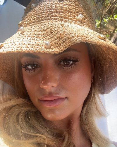 Kylan Darnell black floral bikini with wide-brimmed straw hat