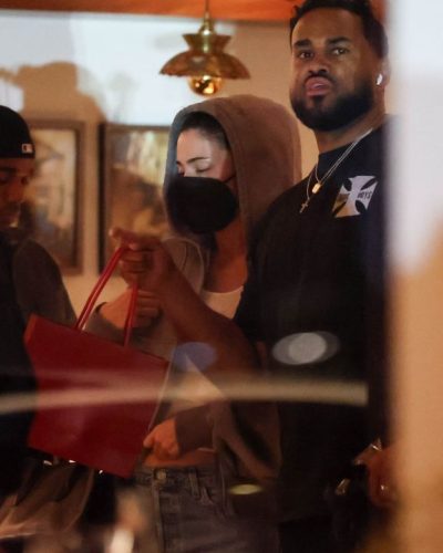 Kylie Jenner gray hoodie and fitted denim jeans