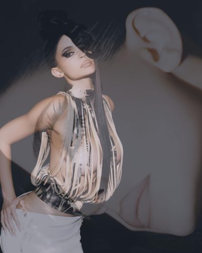 Kylie Jenner styled in bright yellow jacket and stylish sandals