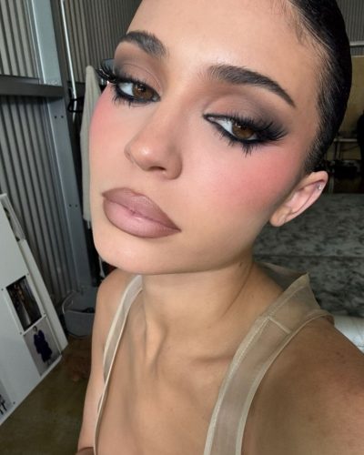 Kylie Jenner yellow jacket paired with trendy sandals