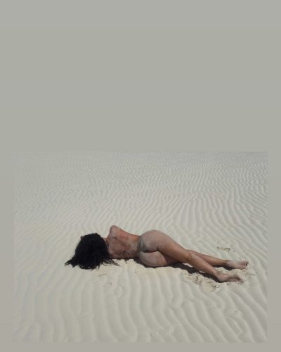 Kylie Jenner in beige bikini by the beach.