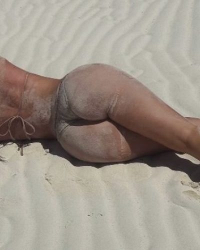 Kylie Jenner in classic beige bikini by the coastline.