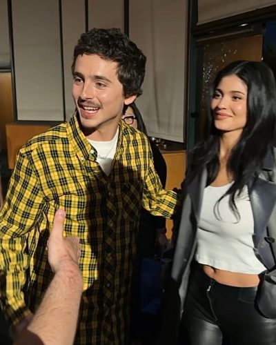 Kylie Jenner styled with fitted white crop top and black pants.