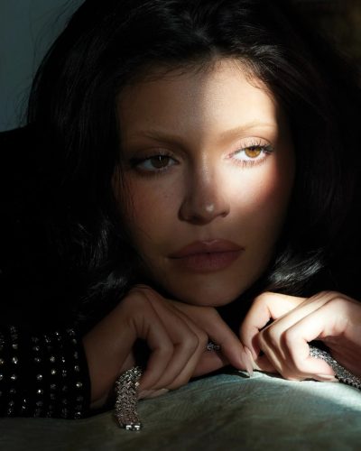 Kylie Jenner high-waisted beige trousers and black knee-high boots