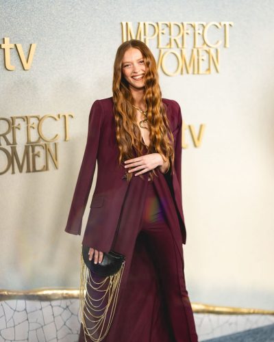 Larsen Thompson with long hair and striking maroon suit