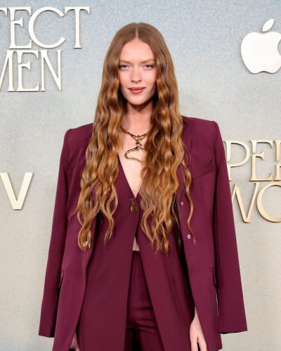 Larsen Thompson in tailored maroon suit paired with gold jewelry