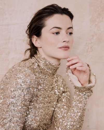 Lauren McQueen in cream dress with sophisticated silhouette