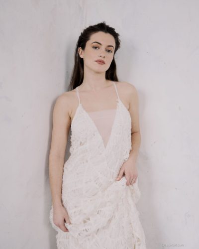 Lauren McQueen in cream dress with elegant black sandals