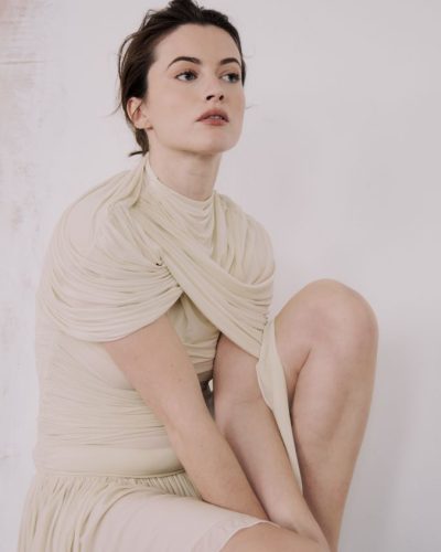 Lauren McQueen in elegant cream dress with delicate detailing