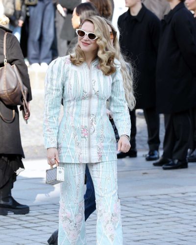 Lea Seydoux wearing sleek nude heels with tailored mint green outfit