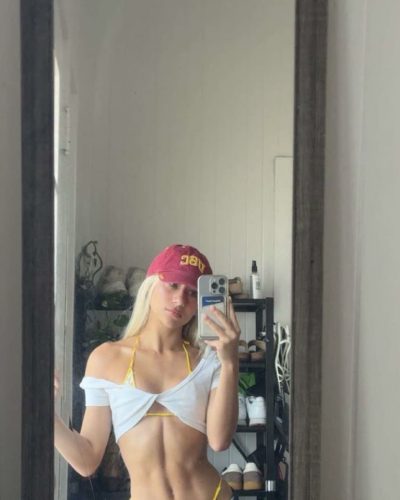 Leila Faler in playful yellow polka-dotted bikini and red hat