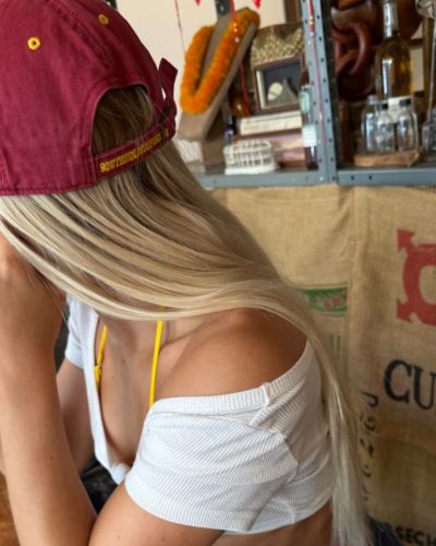 Leila Faler in yellow bikini paired with a red beach hat