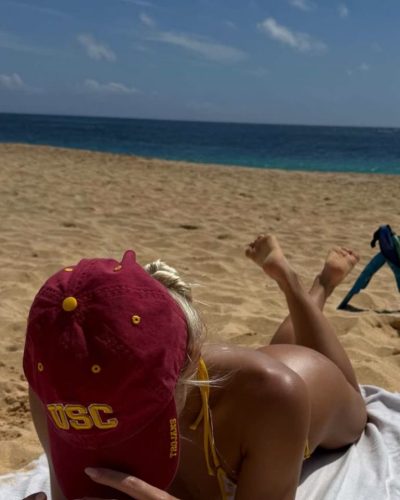 Leila Faler in bright yellow bikini with red casual hat