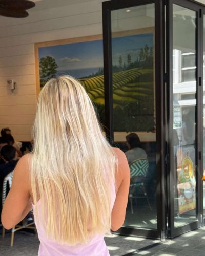 Leila Faler dressed in a white crop top and shorts