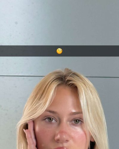 Leila Faler dressed in a white crop top and shorts