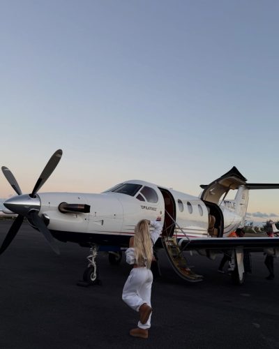 Leila Faler in a white cropped top and light shorts