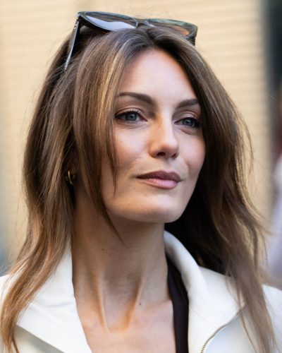 Leila George wearing tailored white blazer over brown bodysuit