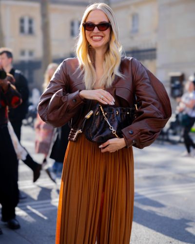 Leonie Hanne sports a sleek brown dress with leather accents.