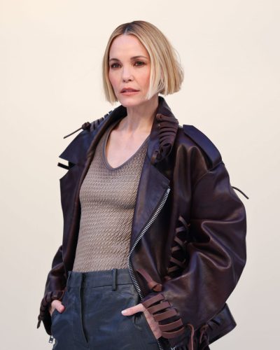 Leslie Bibb light taupe top paired with sleek dark pants.