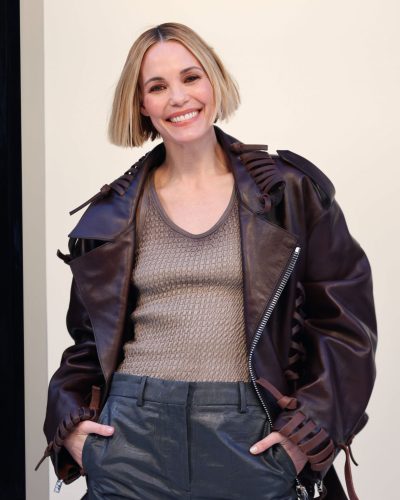 Leslie Bibb chic brown leather jacket and dark tailored pants.