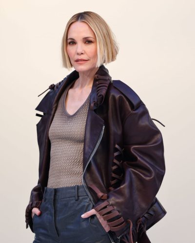 Leslie Bibb brown leather jacket with ruffles and tailored pants.