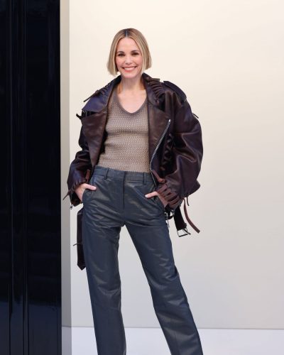 Leslie Bibb stylish brown leather jacket with unique shoulder ruffles.