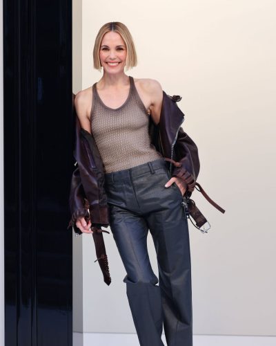 Leslie Bibb fashionable brown leather jacket with intricate detailing.