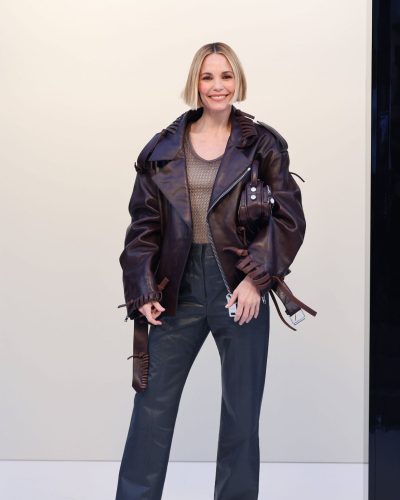Leslie Bibb ruffled brown leather jacket and light-toned top.