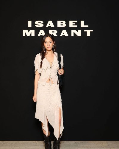 Lily Chee in delicate lace-up top and ruffled skirt