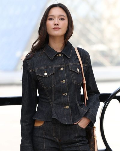 Lily Chee in chic tailored denim trousers and stylish heels