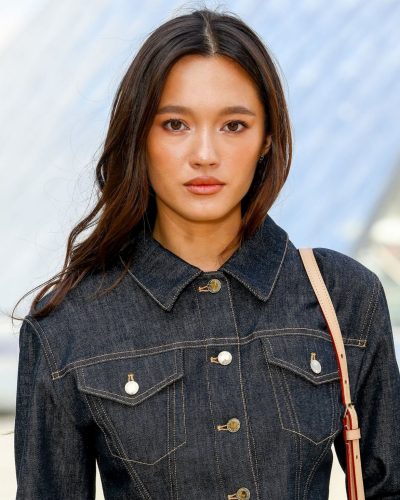 Lily Chee wearing dark denim jacket with golden buttons