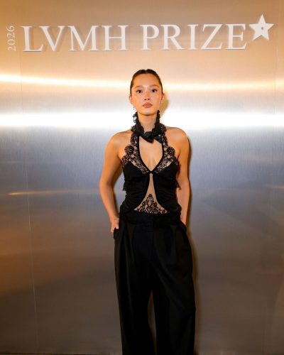 Lily Chee in a black lace top paired with tailored pants