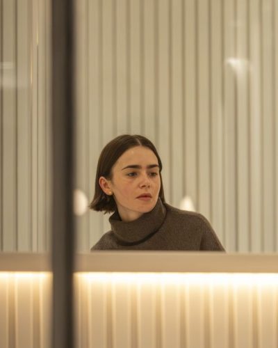 Lily Collins in chic brown leather jacket and cozy layers