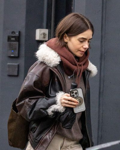 Lily Collins wearing brown boots with layered winter attire
